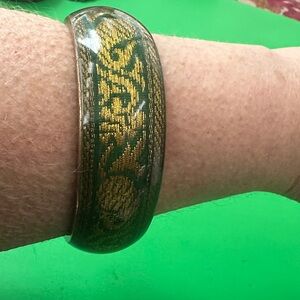 Gold and green vintage lucite bracelet with tapistery motif.